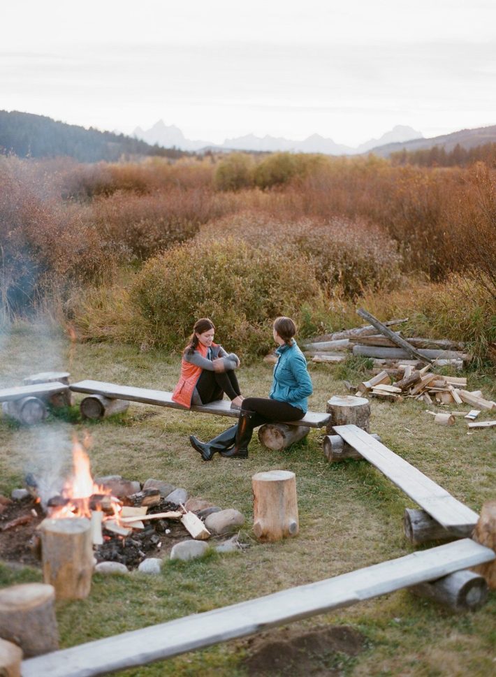 Girls around a firepit during sunset at Turpin Meadow Ranch in Grand Teton National Park