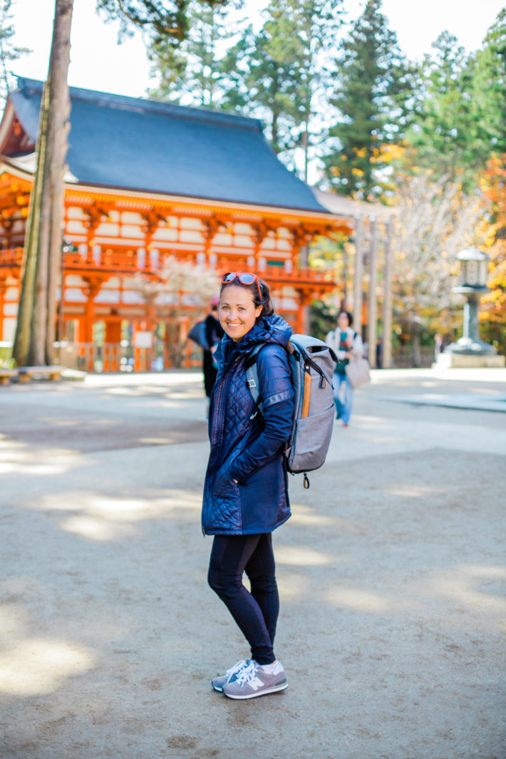 Travel Blogger wearing Athleta Rock Springs Jacket while visiting a shrine in Japan