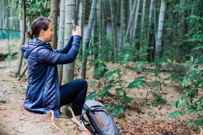 Athleta Rock Springs Jacket on travel blogger taking a photo in the bamboo forests of Kyoto, Japan