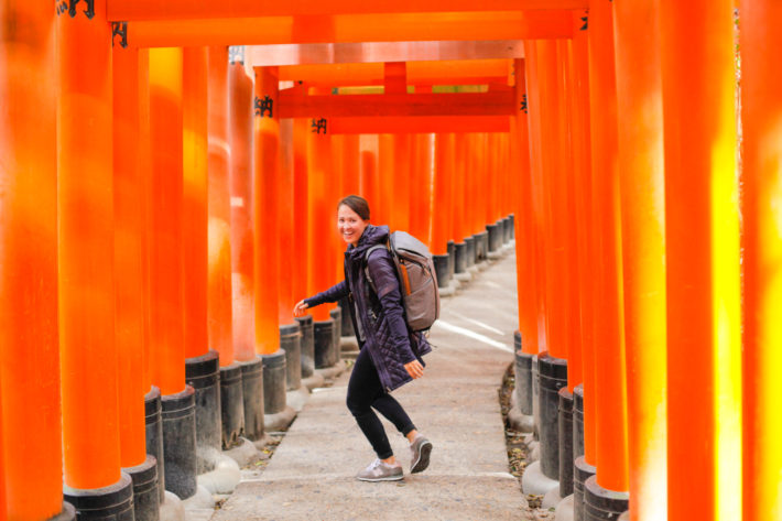 Travel Blogger at Fushimi Inari Taisha wearing Athleta Rock Springs Jacket in Kyoto Japan