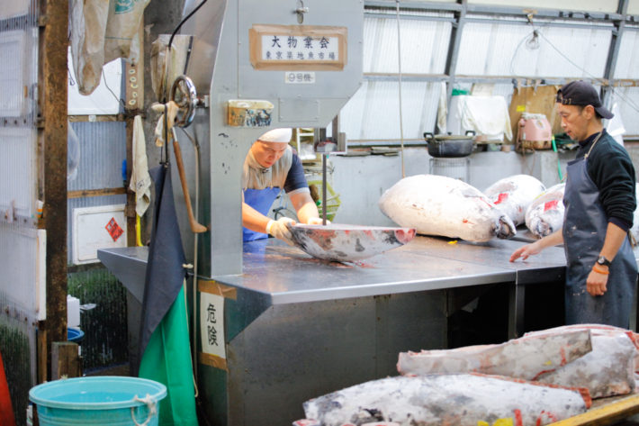 Tuna is sectioned and cut after the budding of the Tsukiji Fish Market in Tokyo