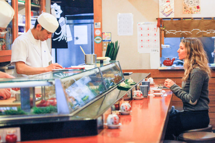 Travel Blogger enjoys a tuna sushi breakfast after the Tsukiji fish market in Tokyo Japan