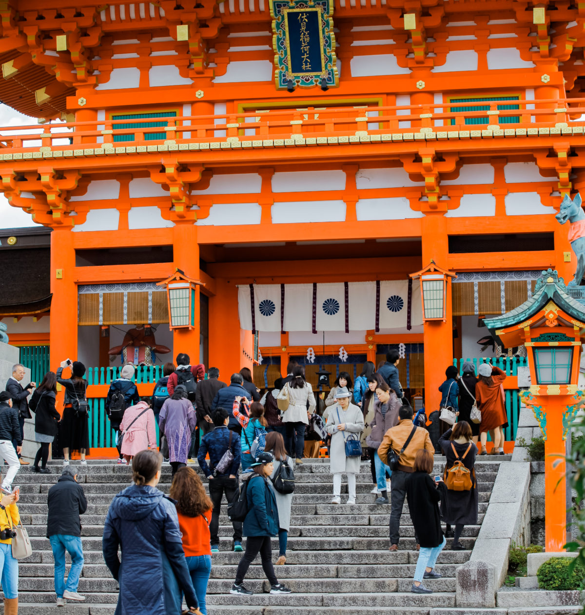 Travel blogger stands in front of Japanese shrine in Kyoto