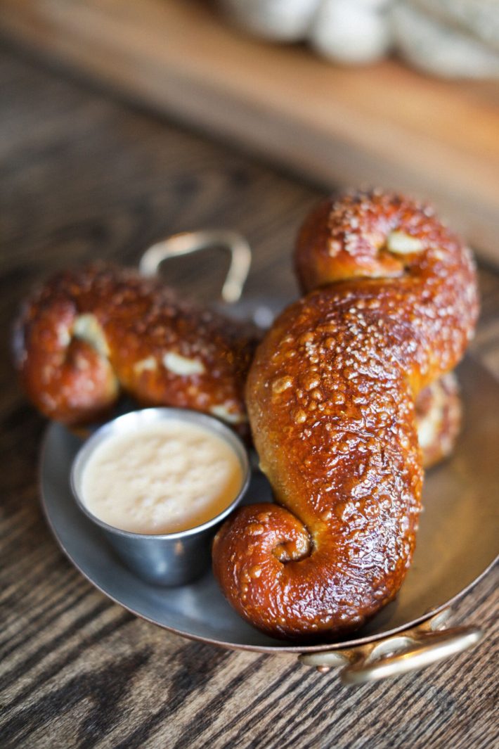 jackson hole blogger digs into mustache pretzel from the handle bar in the four season resort