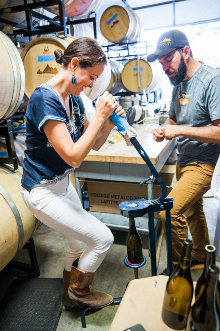 Jackson Hole Blogger at Jackson Hole Winery corking a wine bottle