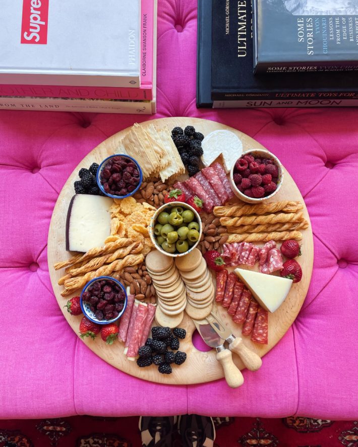 Charcuterie board on pink couch