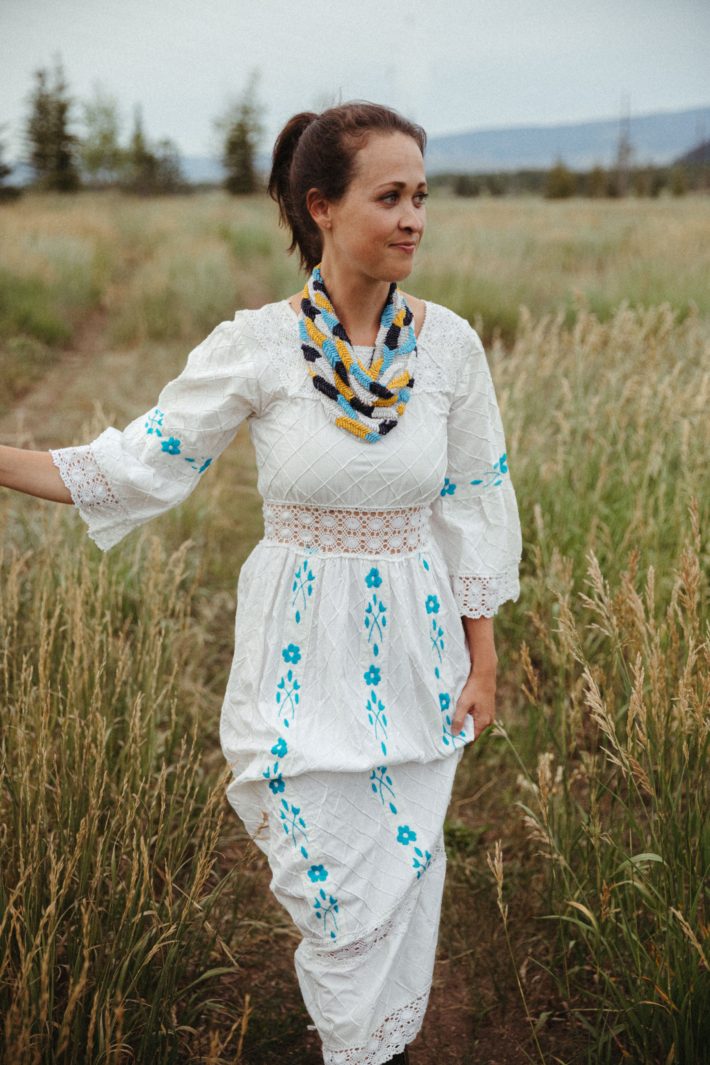 Jackson Hole blogger in white dress in wyoming field