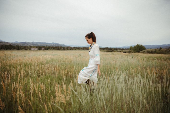 Jackson Hole blogger in white dress in wyoming field