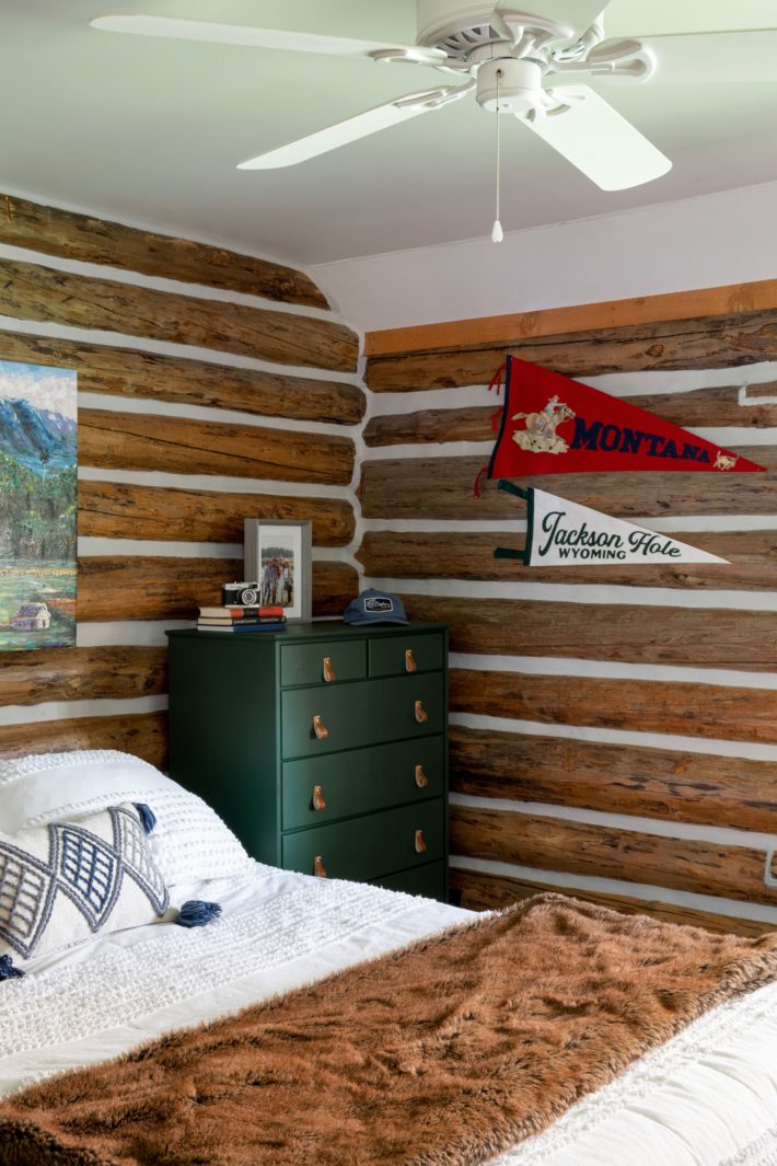 emerald green dresser in log cabin with leather pulls