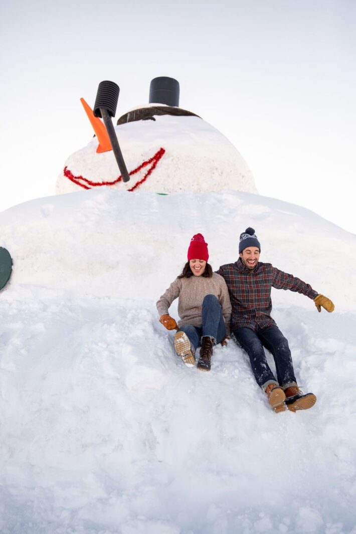 couple on large snowman jackson hole