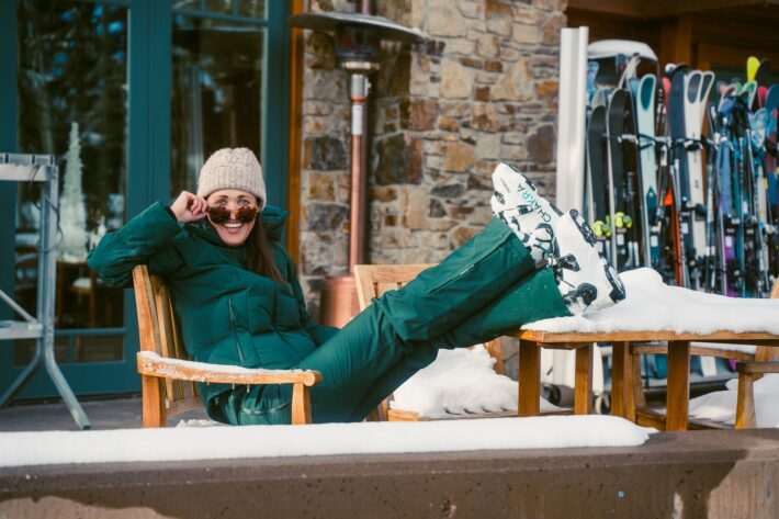 skier girl in halfdays carson bib and georgie puffer in alpine green