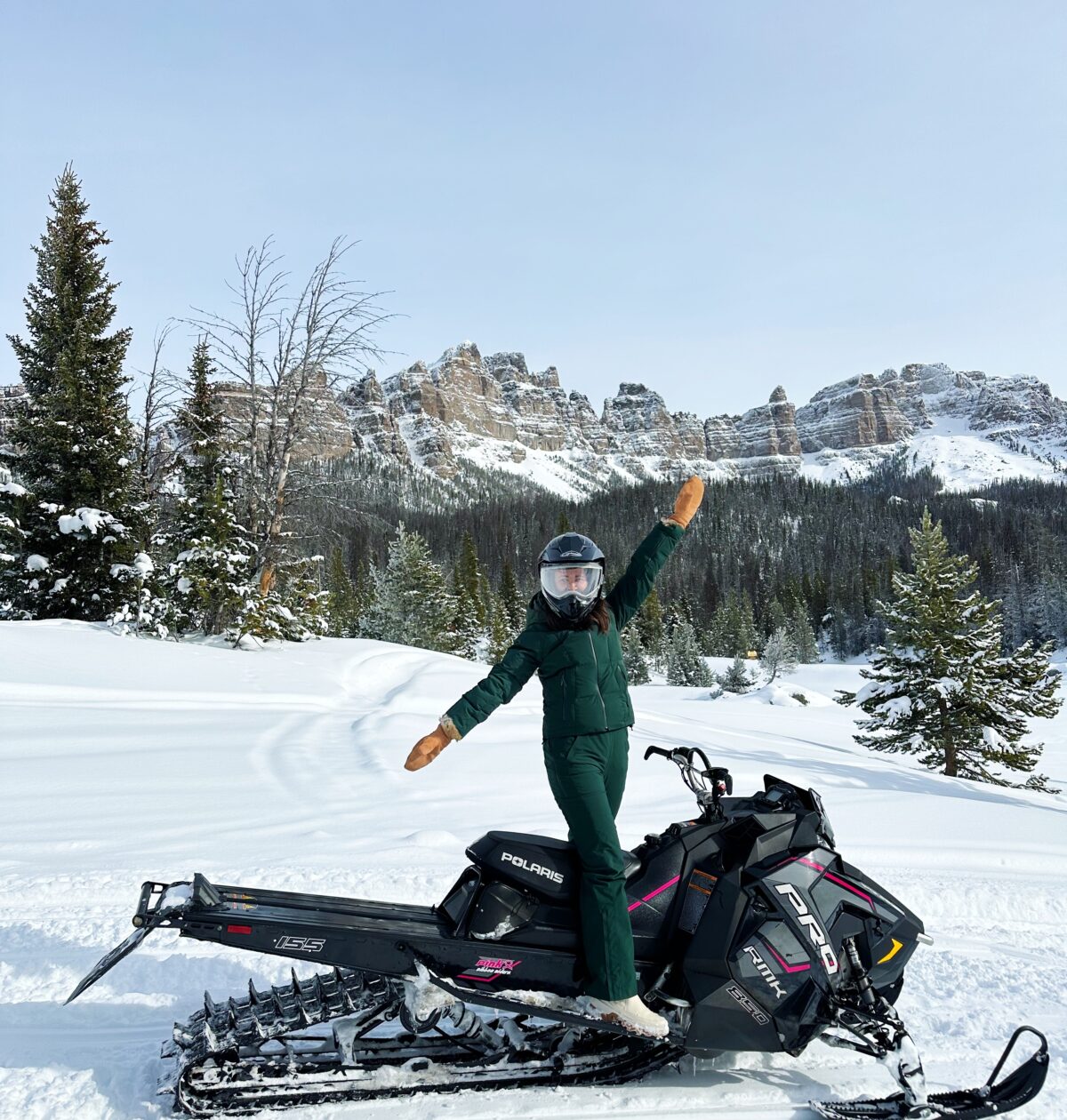 girl in halfdays ski wear snowmobiling at brooks lake lodge and spa